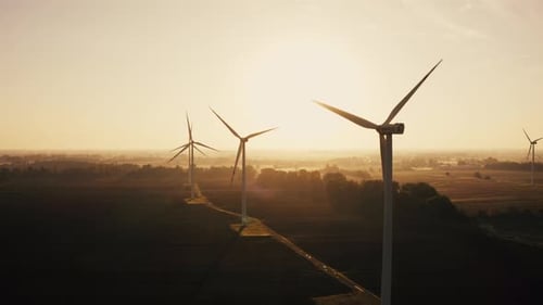 Aerial View of a Wind Turbine Farm During Sunset or Sunrise