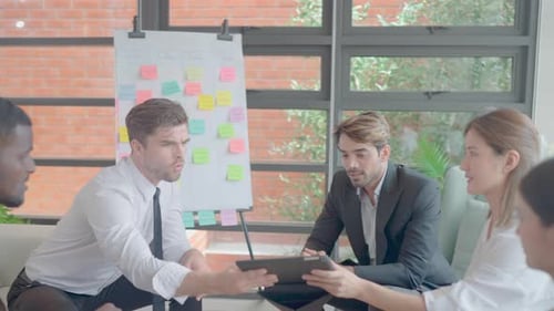 Group of multi-ethnic business men and women join to discuss in working area using board