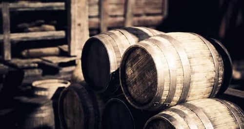 Rustic Wooden Barrels Stacked in an Outdoor Storage Area During Daylight