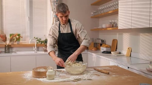 Young Adult Baking Dough in Bright Kitchen