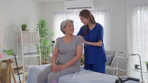Portrait of Asian caregiver examine senior woman patient at nursing home.