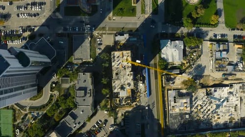 Vertical Top View of Construction Crane in City Stock Footage Building Under Construction in Center