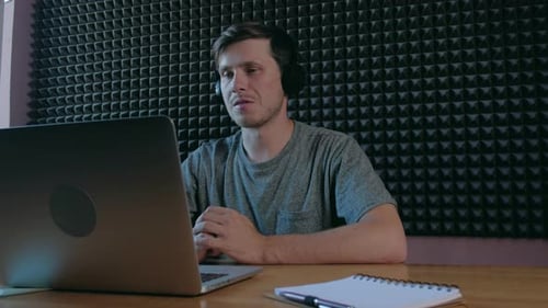 Young Man Video Conferencing on Laptop in Office