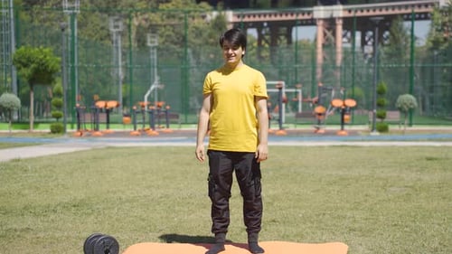 Young Adult Doing Toe Touches in Park