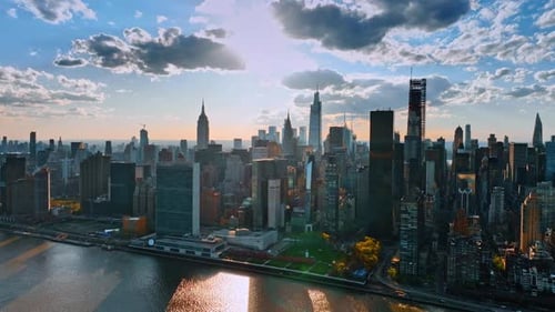 Approaching the sunny skyline of New York. Stunning skyscrapers under the fluffy grey clouds.