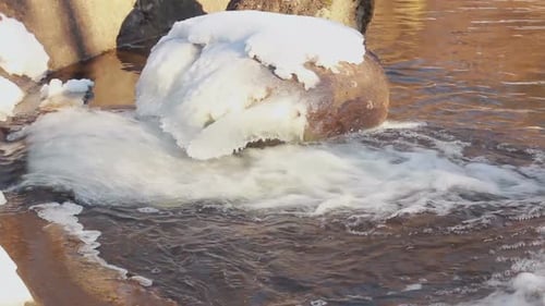 Winter Water. Water Flow in Winter. Small Waterfall in Winter. Sunlight. Flowing
