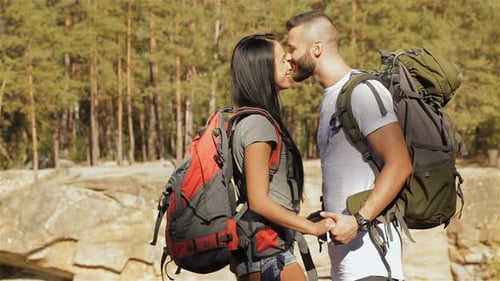 Hiking Couple Hugs Near the Cliff