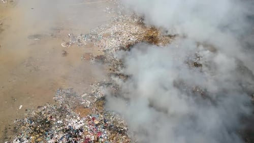 Aerial view of landfill with burning trash piles