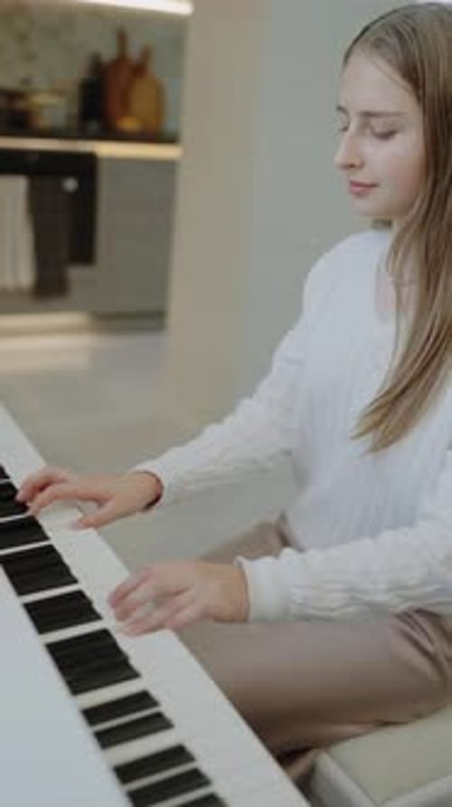 Young Woman Playing Piano and Singing Indoors