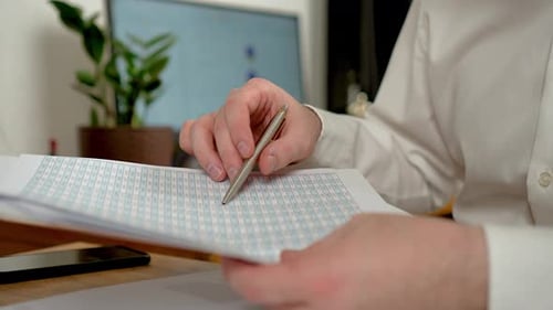 Closeup Businessman Looking at Professional Document Agreement on Table with an in Hand Employee