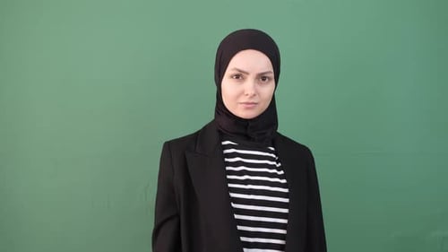 Woman Gestures Cannot Hear Against Green Background