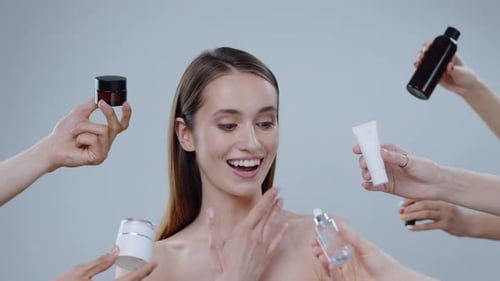 Young Woman Smiles Surrounded by Skincare Products