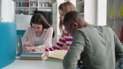 Students Work Upon Presentation in Library