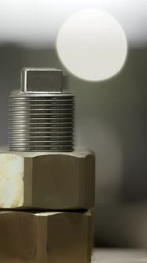 A Close Up View of an Industrial Valve Component Surrounded By a Bokeh Background Effect Stock Clip