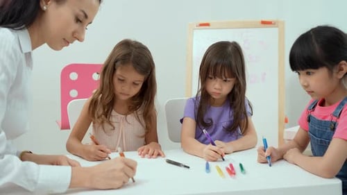 Teacher and Students Drawing Together in Classroom