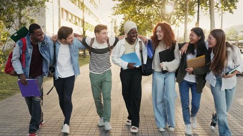 Group of Multiracial Gen z Student Friends Embracing Each Other and Walking Together in the City