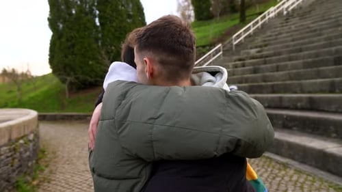 Young caucasian gay couple showing affection in park