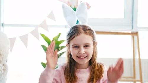 Smiling Girl Wearing Easter Bunny Ears Indoors
