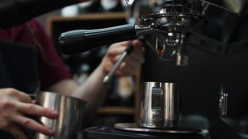 Barista Whips Milk with Tool of Coffee Machine in Cafe