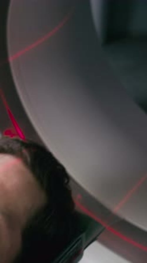Close Up of Man Lying inside Tomography Scanner during Diagnostic Procedure