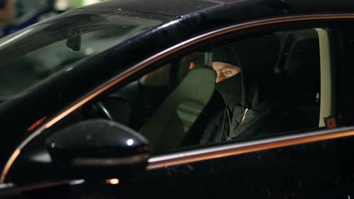 Masked Man in Black Car at Night