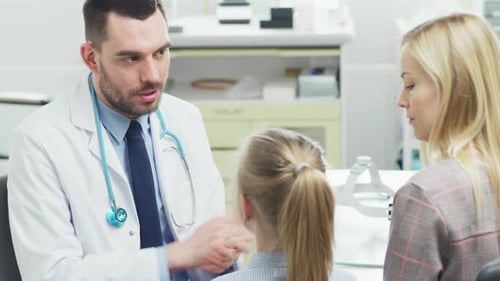 Doctor Talking with Mother and Child in Office