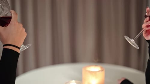 Romantic Wine Toast Between Two People at Table