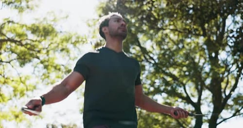 Athletic Man Jump Roping Outdoors on Sunny Day