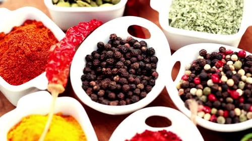 Vibrant Assortment of Colorful Spices in White Ceramic Bowls