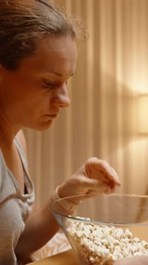 Blonde Haired Woman Eating Popcorn from Bowl