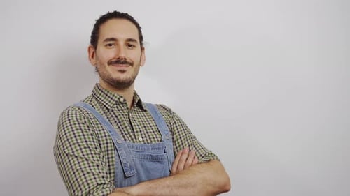Friendly Young Adult Smiling with Arms Crossed Indoors