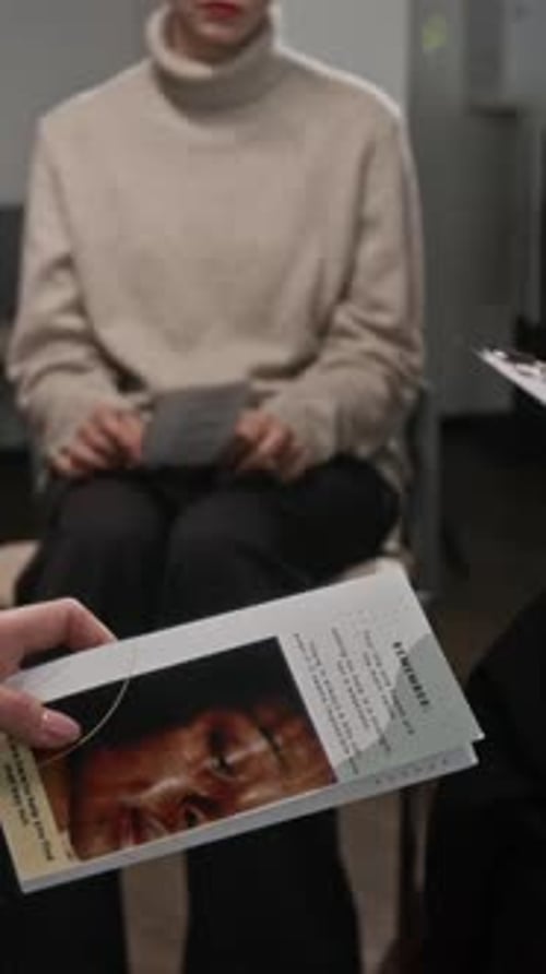 Hands Holding Brochure in Support Group Vertical