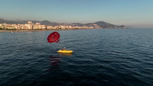 Parasailing Over the Sea at the Most Beautiful Sunset Hour
