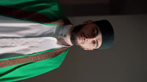Portrait of a Muslim man praying on his knees in Ramadan and giving thanks for support and spiritual