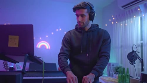 Man Mixing Music With DJ Gear at Home
