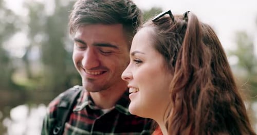 Hiking, couple smile and hug on adventure in forest together with a smile on travel and journey