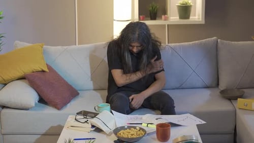 Man Wakes Up on Couch, Displays Signs of Distress