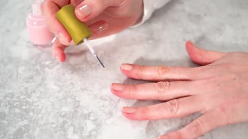 Woman Finishing Her Manicure at Home with Simple Manicure Tools Painting Nails with Fresh Nail
