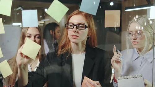 Business Team Brainstorming with Sticky Notes in Office