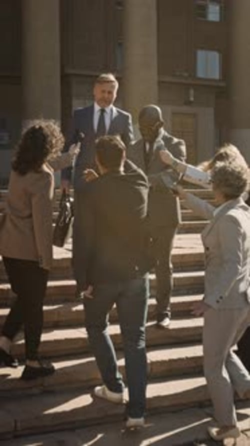 Reporters Rushing to Interview Lawyer Walking out of Court with Bodyguard