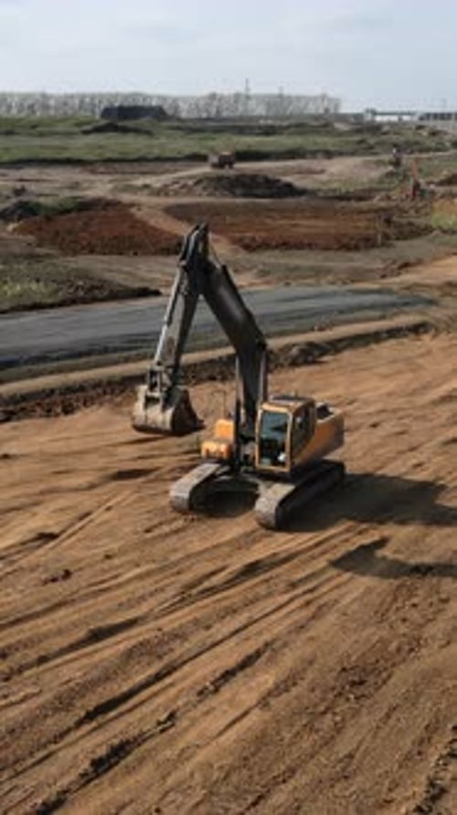 Excavator Leveling Ground During Road Construction Clip