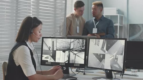 Female Security Service Worker Monitoring CCTV Cameras