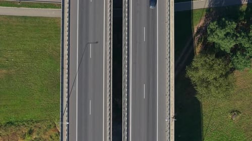 Aerial View of Divided Highway Bridge Traffic Surrounded by Greenery