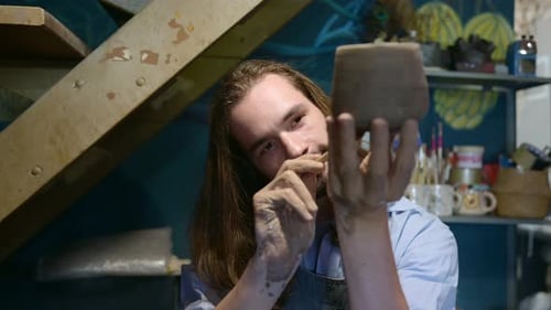 Pottery artist, Young making a piece of clay molding calmly