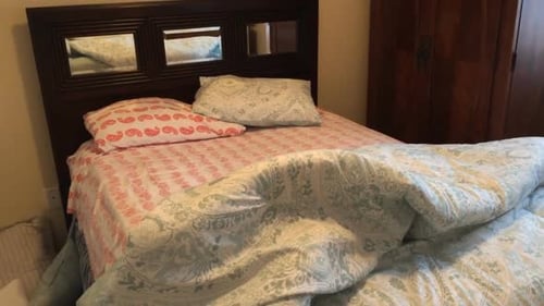 View of messy unmade bed in bedroom of house in the morning