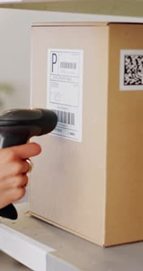 Hand Scanning Barcode on Package