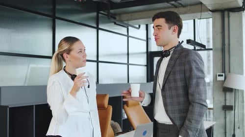 Business Meeting Taking Place at a Modern Office with Two Professionals Discussing Ideas and