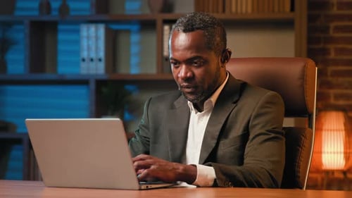 Focused Businessman Typing on Laptop Working in Office Sick Unhealthy African American Man Sneezes
