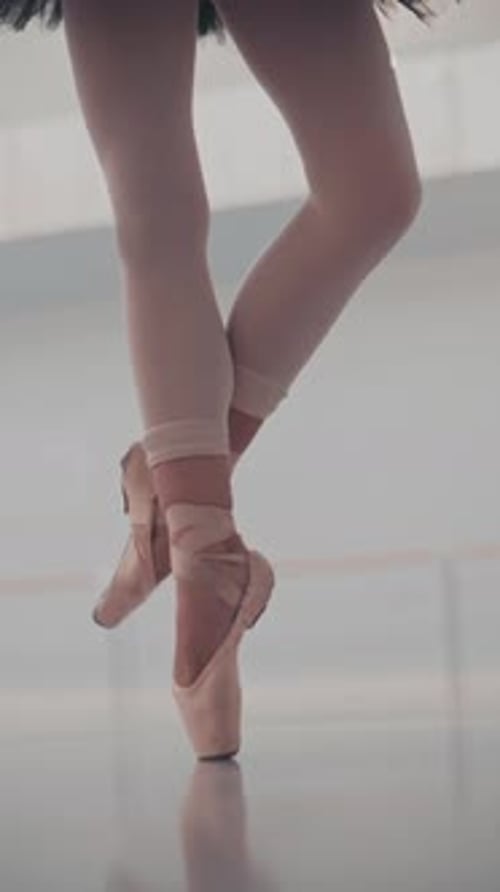 Close up of beautiful ballet dancer's legs in pointe. Woman practices exercises. Ballerina's feet.