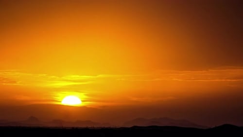 Beautiful Sunrise Over Silhouette of Mountains